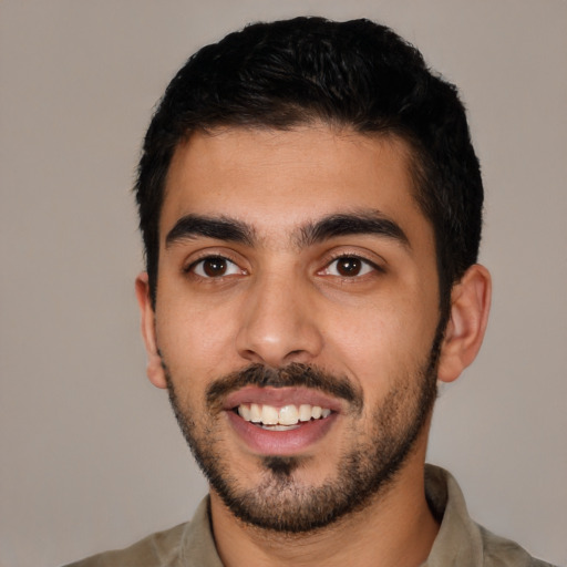 Joyful latino young-adult male with short  black hair and brown eyes