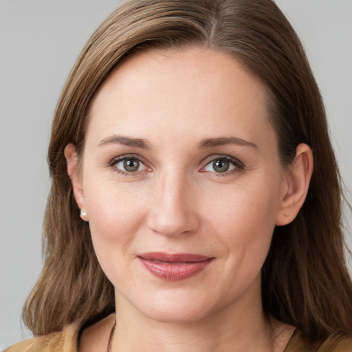 Joyful white young-adult female with long  brown hair and grey eyes