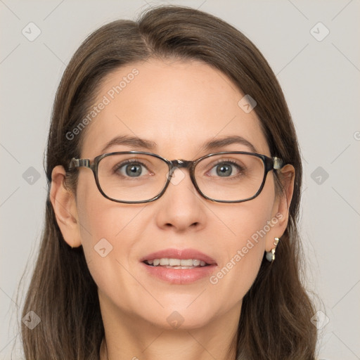 Joyful white adult female with long  brown hair and grey eyes