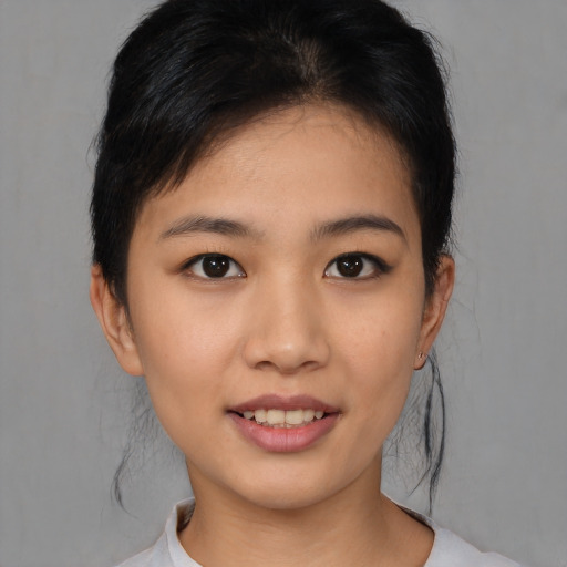 Joyful asian young-adult female with short  black hair and brown eyes