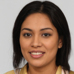 Joyful latino young-adult female with medium  brown hair and brown eyes