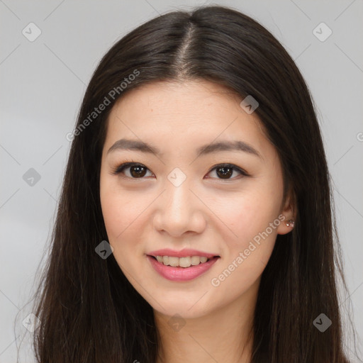 Joyful asian young-adult female with long  brown hair and brown eyes