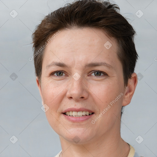 Joyful white adult female with short  brown hair and grey eyes