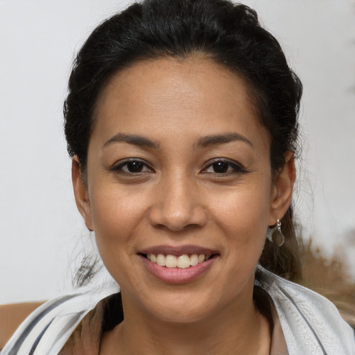 Joyful latino young-adult female with short  brown hair and brown eyes