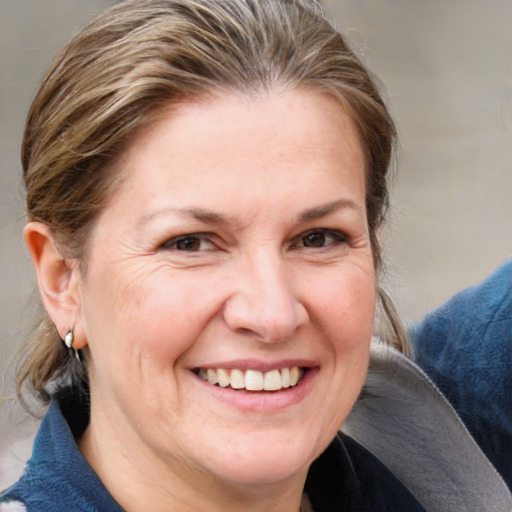 Joyful white adult female with medium  brown hair and blue eyes