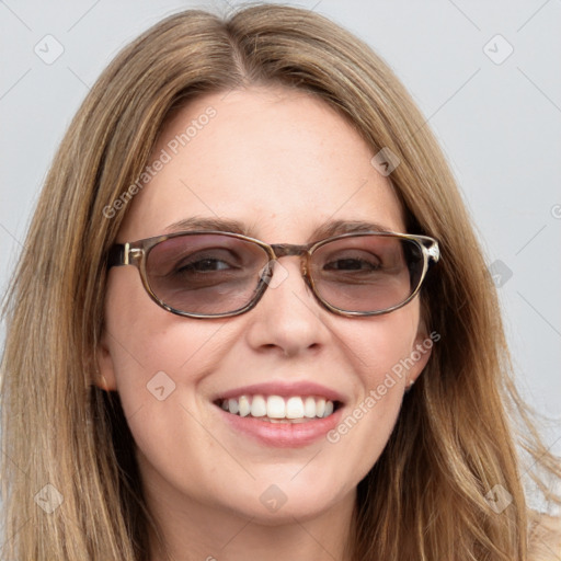 Joyful white young-adult female with long  brown hair and blue eyes