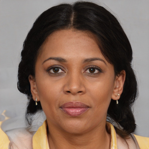 Joyful black adult female with medium  brown hair and brown eyes