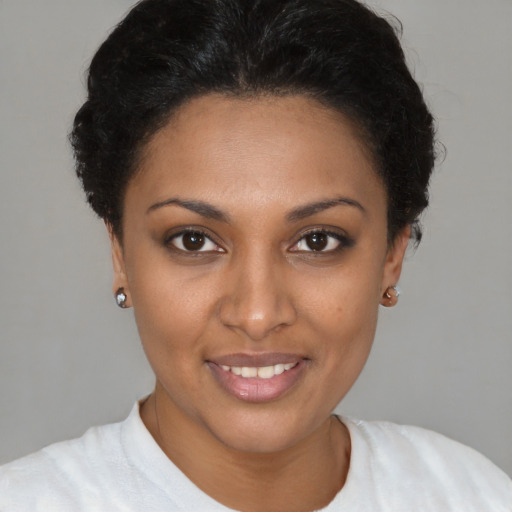Joyful black young-adult female with short  brown hair and brown eyes
