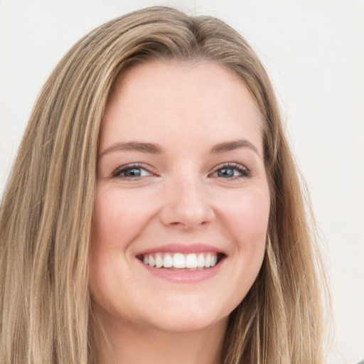 Joyful white young-adult female with long  brown hair and green eyes