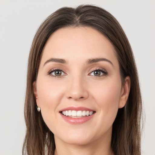 Joyful white young-adult female with long  brown hair and grey eyes