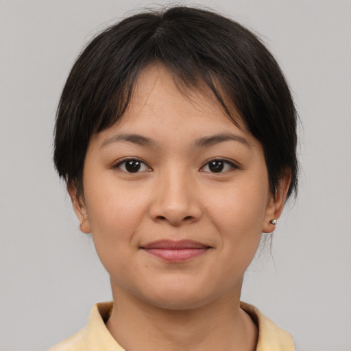 Joyful asian young-adult female with short  brown hair and brown eyes