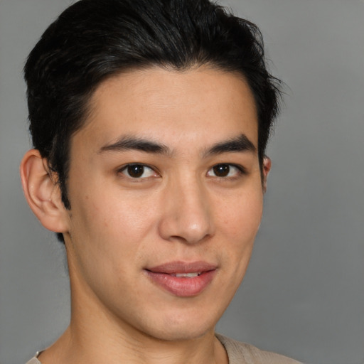 Joyful asian young-adult male with short  brown hair and brown eyes