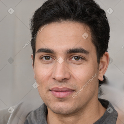 Joyful white young-adult male with short  black hair and brown eyes