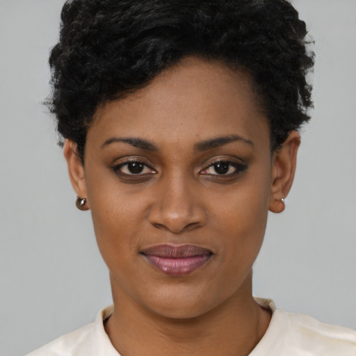 Joyful latino young-adult female with short  black hair and brown eyes