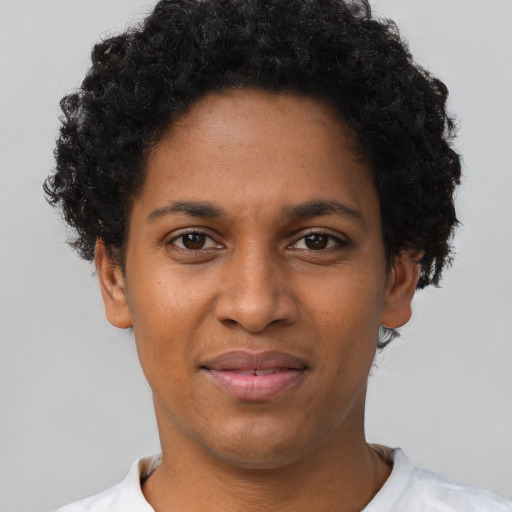 Joyful black young-adult female with short  brown hair and brown eyes