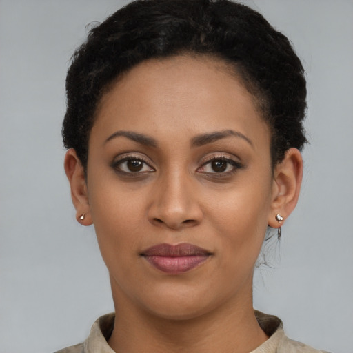 Joyful latino young-adult female with short  brown hair and brown eyes