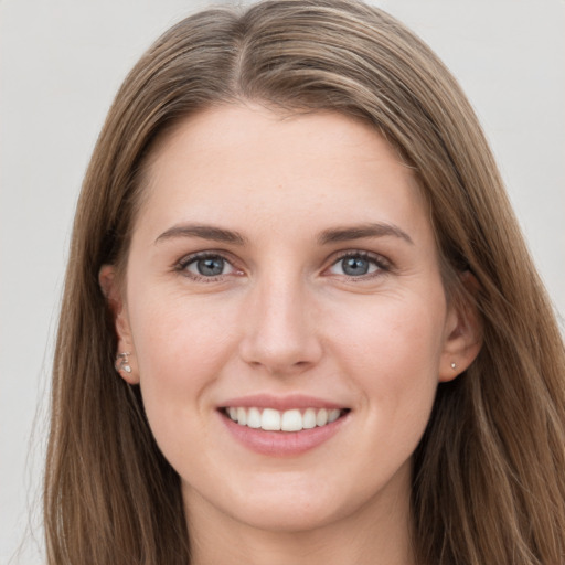 Joyful white young-adult female with long  brown hair and grey eyes