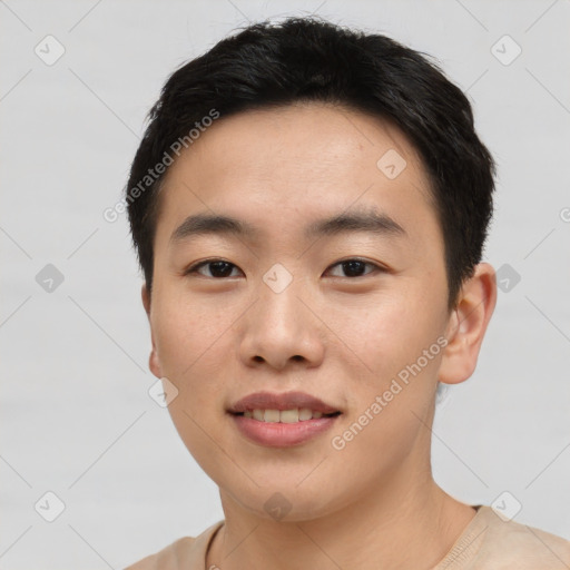 Joyful asian young-adult male with short  black hair and brown eyes