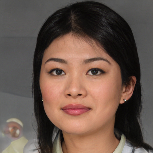 Joyful asian young-adult female with medium  brown hair and brown eyes