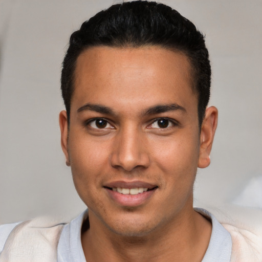 Joyful white young-adult male with short  black hair and brown eyes