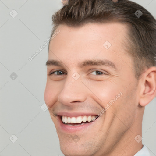 Joyful white young-adult male with short  brown hair and brown eyes