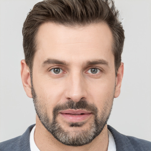 Joyful white adult male with short  brown hair and brown eyes