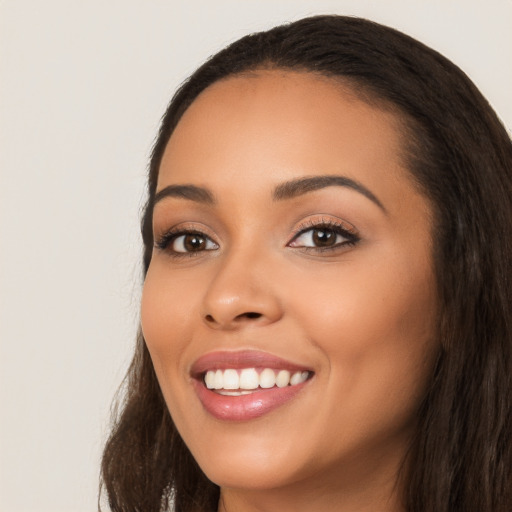 Joyful latino young-adult female with long  black hair and brown eyes