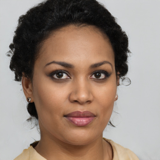 Joyful black young-adult female with short  brown hair and brown eyes