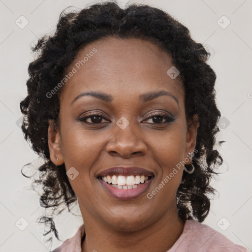 Joyful black young-adult female with long  brown hair and brown eyes