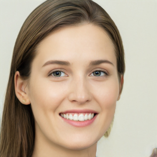 Joyful white young-adult female with long  brown hair and grey eyes