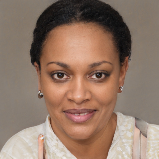 Joyful black young-adult female with short  black hair and brown eyes