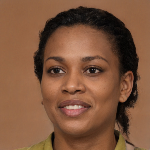 Joyful black young-adult female with medium  brown hair and brown eyes