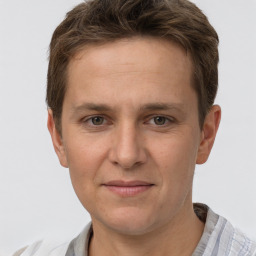 Joyful white adult male with short  brown hair and grey eyes