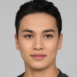 Joyful asian young-adult male with short  black hair and brown eyes