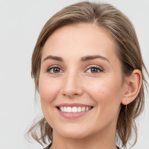 Joyful white young-adult female with medium  brown hair and blue eyes