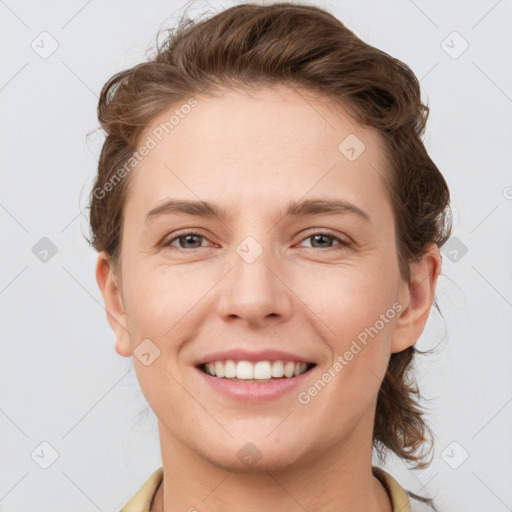 Joyful white young-adult female with short  brown hair and grey eyes