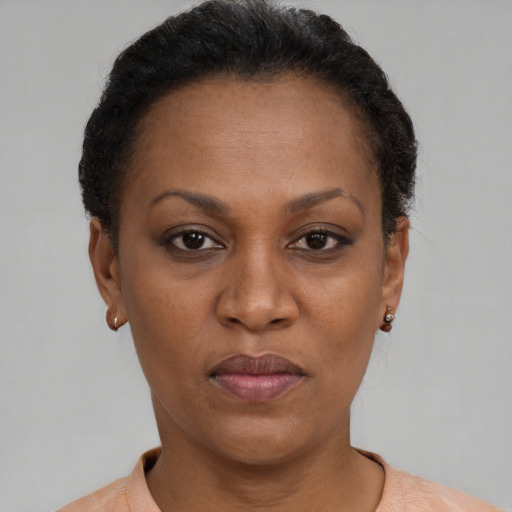 Joyful black adult female with short  brown hair and brown eyes