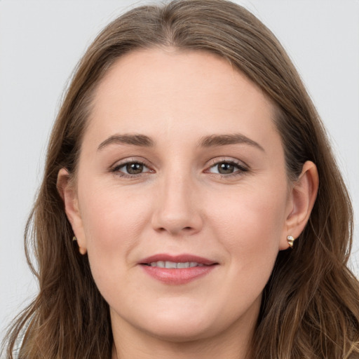 Joyful white young-adult female with long  brown hair and grey eyes