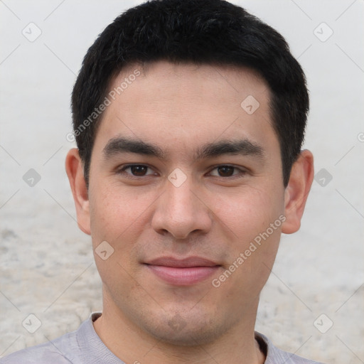 Joyful asian young-adult male with short  black hair and brown eyes