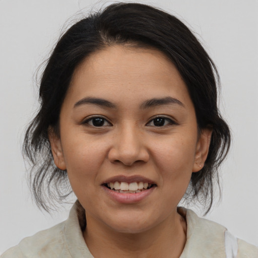 Joyful latino young-adult female with medium  brown hair and brown eyes