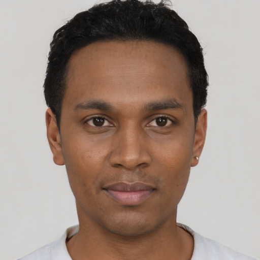 Joyful black young-adult male with short  black hair and brown eyes