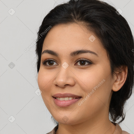 Joyful latino young-adult female with medium  brown hair and brown eyes