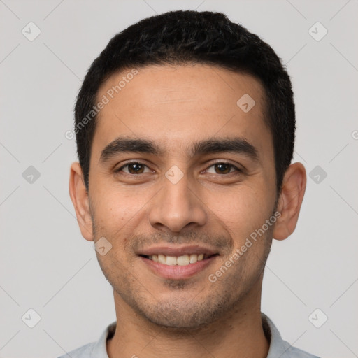 Joyful latino young-adult male with short  black hair and brown eyes