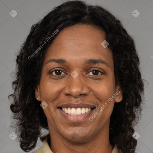 Joyful black young-adult female with long  brown hair and brown eyes