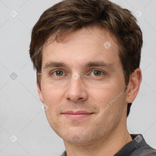 Joyful white adult male with short  brown hair and grey eyes