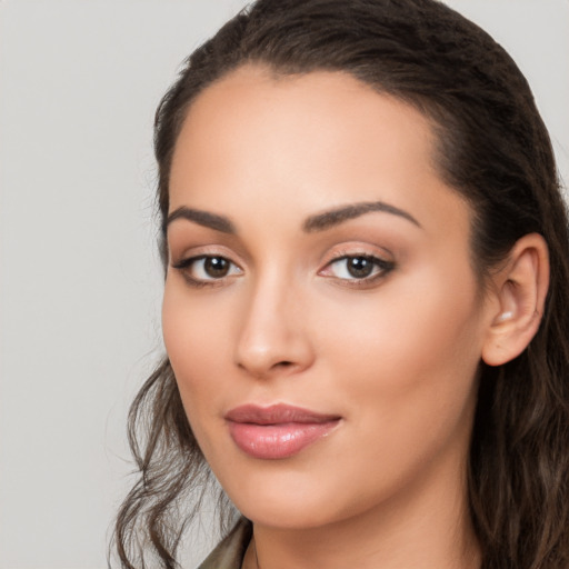 Joyful latino young-adult female with long  brown hair and brown eyes