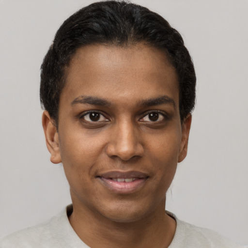 Joyful black young-adult male with short  brown hair and brown eyes