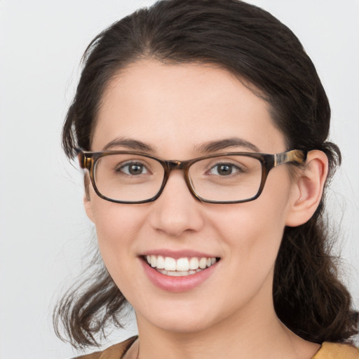 Joyful white young-adult female with medium  brown hair and blue eyes