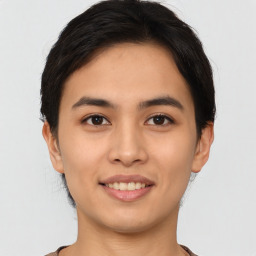 Joyful asian young-adult female with short  brown hair and brown eyes