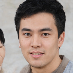 Joyful asian young-adult male with short  black hair and brown eyes